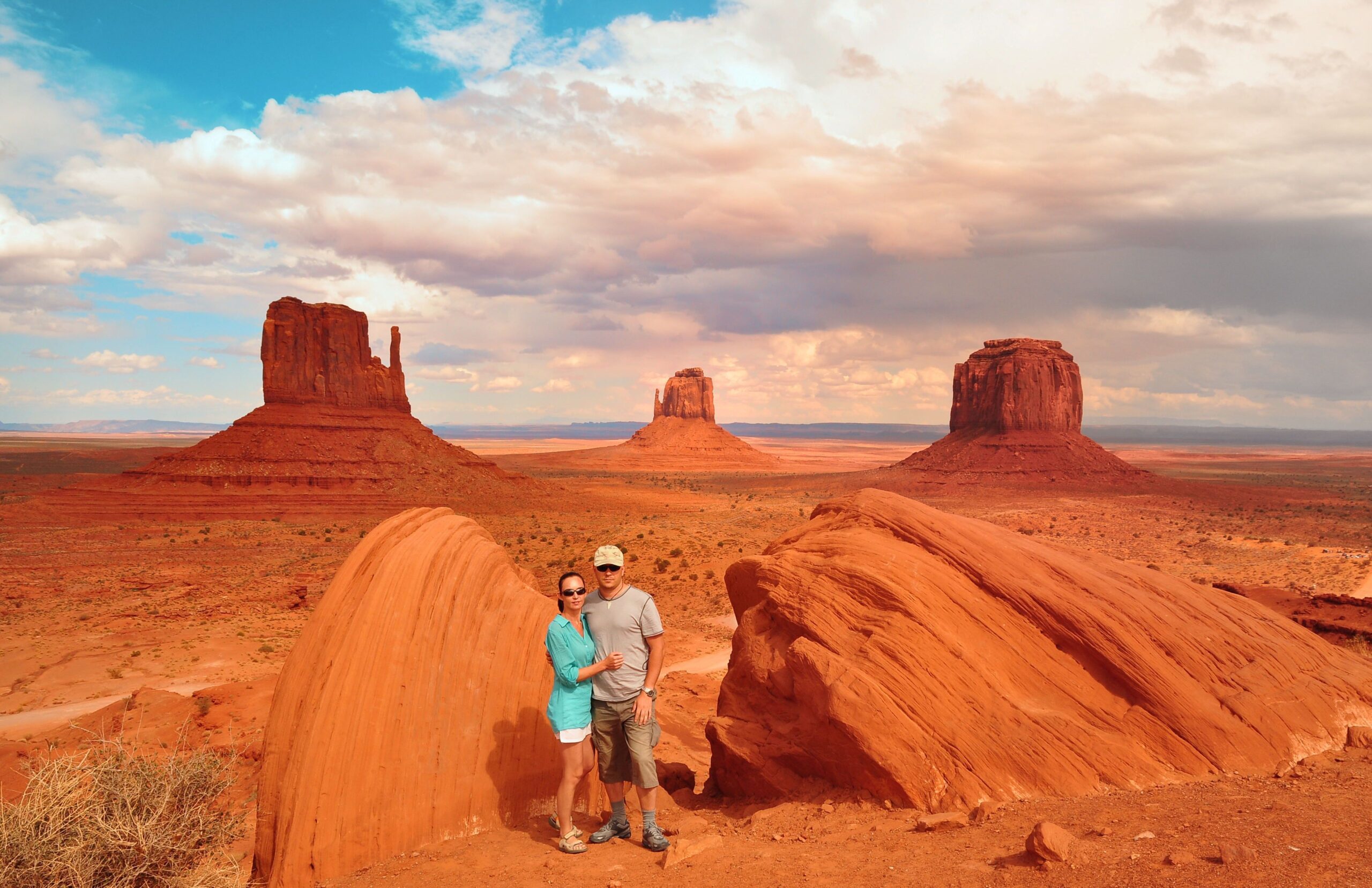 Couple beside the red rocks at Monument Valley Navajo Tribal Park